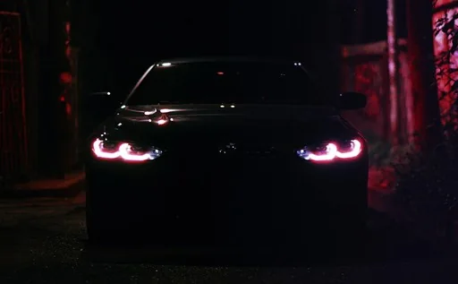 Car headlights against dark red garage lighting